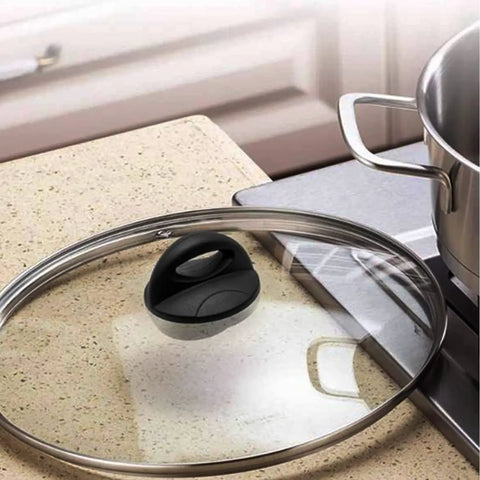 Pot Lid Knob Replacement For Crockpot And Slow Cooker Lids, Bakelite handle on a glass saucepan lid on a kitchen counter.