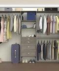 Kick Your Closet Cleanup Into High Gear With This Sturdy Wood System Featuring Four Slide Out Drawers Flexible Shelving And Three Expandable Rods That Honestly Maximizes Every Inch In Sleek Graphite Grey in a closet setup with clothing and shoes.