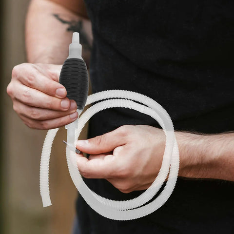 Heavy Duty Manual Oil Transfer Pump With Thick Plastic Siphon Tube for Effortless Fluid Extraction And Gas Cleanup, held with a flexible siphon tube.