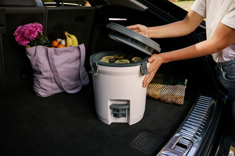 Hardcore Two Gallon Insulated Water Jug Featuring Double Wall Foam Build Keeps Your Daily Hydration Frosty Fresh On Any Campout Or Weekend Grind Session in car trunk with drinks