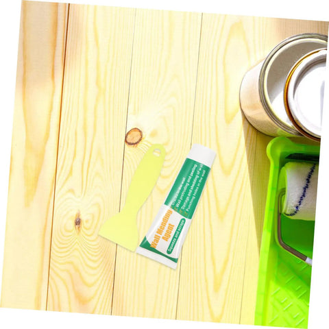 Drywall Repair Putty Paste For Quick Hole Patching And Wall Mending Cream next to painter's tools on wooden surface