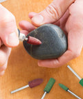 Hands polishing stone with 20 Pcs Rubber Polishing Bits Set For Rotary Tools, 6mm Mounted Cylindrical Head, 120 Grit, Green.
