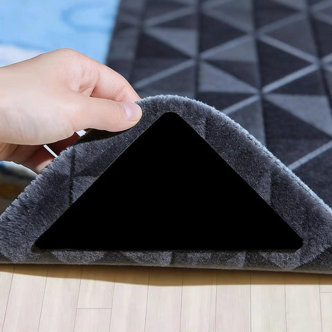 Hand lifting carpet corner showing 16 Pack Rug Gripper Pads For Hardwood Floors And Tile Non Slip Double Sided Tape Reusable No Residue