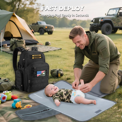 Dad Gear Tactical Diaper Bag Backpack With Changing Pad, Military MOLLE System displayed outdoors with dad changing baby