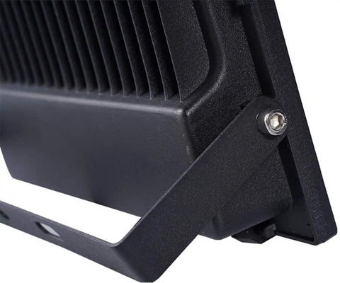 Close-up of JUDYSSY Solar Flood Lights Led Solar Floodlight metal housing with cooling fins and adjustable bracket.