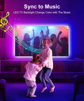 Children dancing in front of TV with 6.56ft RGB LED Backlight Strip For 24-30 Inch TVs, Easy Corner Install Behind Screen, USB Powered 5V, App Remote Control And Music Sync, 16 Million Color Ambience, Ideal Bedroom, PC, And Game Console Setup.