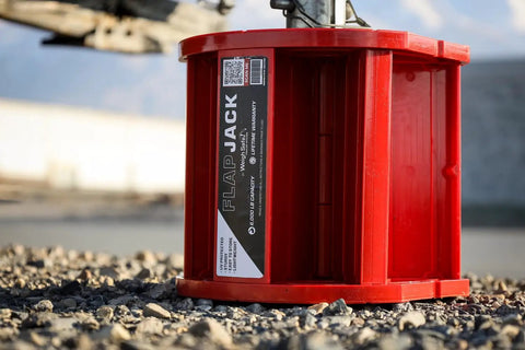 Magnetic RV Jack Stabilizer Blocks Four Pack, Fold Flat Leveling Pads For Trailers Hold Three Tons Each With No Sweat Setup And Ridiculously Roomy Canvas Tote Bag on rocky ground.