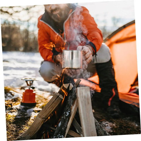 Camping scene with 8 Piece Portable Stainless Steel Camping Cookware Set With Fire Resistant Pots And Bowls by a campfire