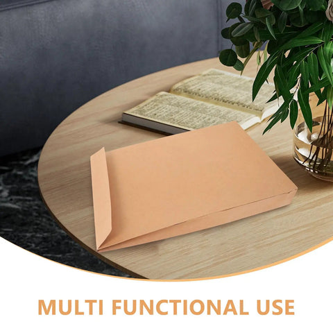 Kraft Mailing Envelopes 10 Pack With Double Sided Adhesive Seal Self Sealing Shipping Bags 238x335x40mm on a table with plant and book