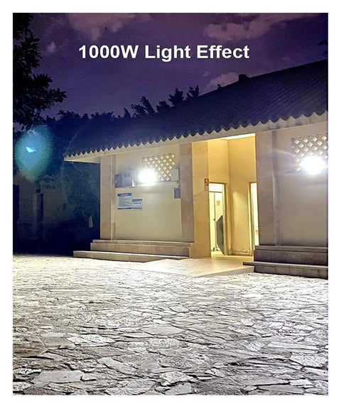 JUDYSSY Courtyard Light Solar Lights Outdoor Garden Solar Led Flood Light Remote illuminating a building at night.