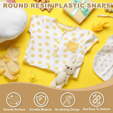 Yellow baby onesie with polka dots surrounded by baby items, highlighting round resin plastic snaps for no-sew design.