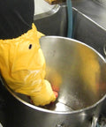 Person using Double Nitrile Coated Full Arm Chemical Resistant Safety Glove With Cotton Poly Liner, 20 Mil Thick for cleaning metal pot