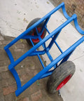 Tough As Nails Heavy Duty Pole Hauler Cart For Concrete Utility Lines And Long Material Transport With Swivel Casters And Bulletproof Steel Chassis Assembly, blue steel frame with red tires.