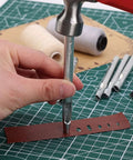 Using Leather Hole Punch Tool Oval 9x5mm Carbon Steel Hollow Punch for precise holes in leather watch bands on crafting mat
