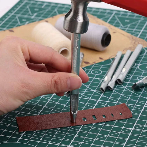 Using Leather Hole Punch Tool Oval 9x5mm Carbon Steel Hollow Punch for precise holes in leather watch bands on crafting mat