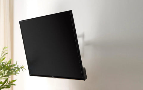 Built Tough Full Motion TV Wall Mount With Effortless Swivel And Tilt Angles For Twenty Six To Fifty Five Inch Screens Handling Up To Eighty Pounds mounted on a wall.