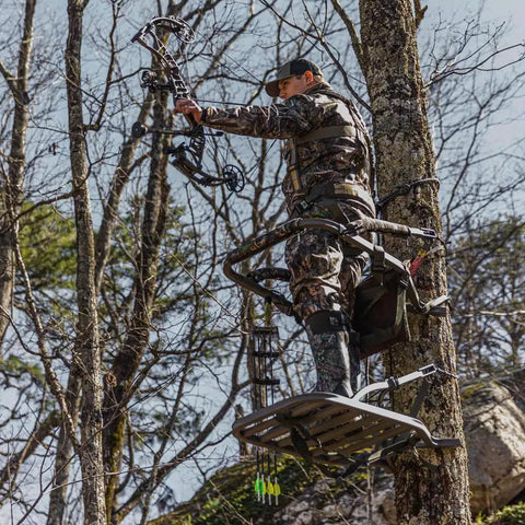 Hunter using Titan Sd Climbing Treestand With Roomier Design Bigger Top Seat Frame And Longer Foot Platform For Large Frame Hunters