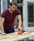 Man using Pro Level Random Orbital Finisher Sander on wooden surface for fast sanding and smoothing.