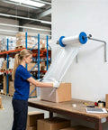 Nail Down Your Packing Routine With This Wall Mounted Bubble Wrap Dispenser, Adjustable Foam Cushioning Roll Holder in use at a shipping station.