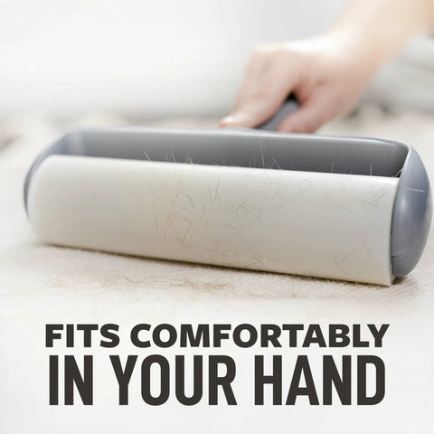 Heavy Duty Lint Roller For Pet Hair And Debris Fifty Percent Stickier Extra Large Roll Perfect For Clothes Furniture Cars And Office Surfaces Sixty Adhesive Sheets Included For Deep Clean Every Mess. Image shows handheld lint roller removing hair from fabric surface.