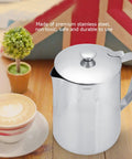 Stainless Steel Milk Frothing Pitcher With Lid And Dripless Spout 2000ml Pro Grade beside cappuccino on wooden table