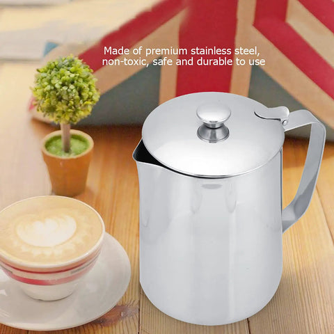 Stainless Steel Milk Frothing Pitcher With Lid And Dripless Spout 2000ml Pro Grade beside cappuccino on wooden table