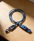 Fencing Foil Cord For Epee Mask With Clamp Clear Body Cable Wire on wooden surface, blue and durable for safe sparring.