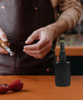 Get These Epic Glue Dispensing Bottles With Precision Nozzle Caps In Sleek Black, Perfect For Diy Crafts, Industrial Fixes, And Travel. A hand holds a glue bottle.
