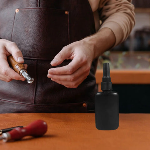 Get These Epic Glue Dispensing Bottles With Precision Nozzle Caps In Sleek Black, Perfect For Diy Crafts, Industrial Fixes, And Travel. A hand holds a glue bottle.