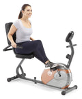 Woman using Recumbent Exercise Bike With Resistance ME 709 For Your Home Gym Step Through Design Magnetic Resistance Smooth Pedal Motion Built Tough 14 Gauge Steel Construction Easy Mount And Dismount.
