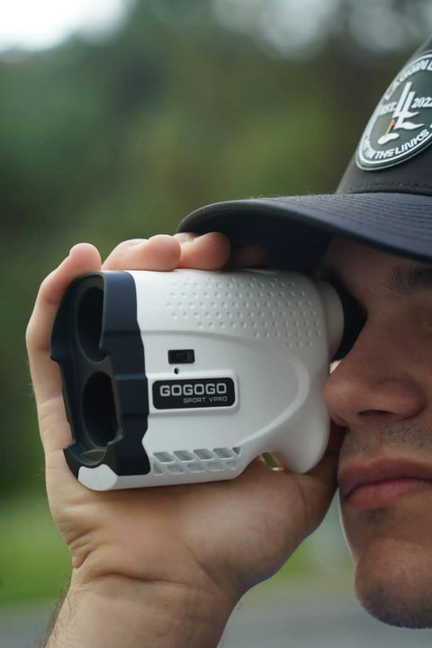 Person using Bang For Your Buck Budget Friendly Golf And Hunting Rangefinder With Seven X Magnification, 1200 Yard Distance