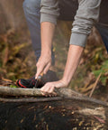 User demonstrating Badass Lightweight Folding Saw For Weekend Campouts And Garden grinding branch with carbon steel blade.