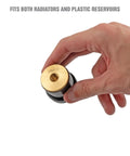 Hand holding Universal Cooling System Adapter Kit for Radiator Pressure Testing, showing brass and black plastic component
