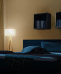 A19 LED Light Bulbs 100W Equivalent Dimmable Warm White 3000K lamp illuminating cozy bedroom with modern decor.