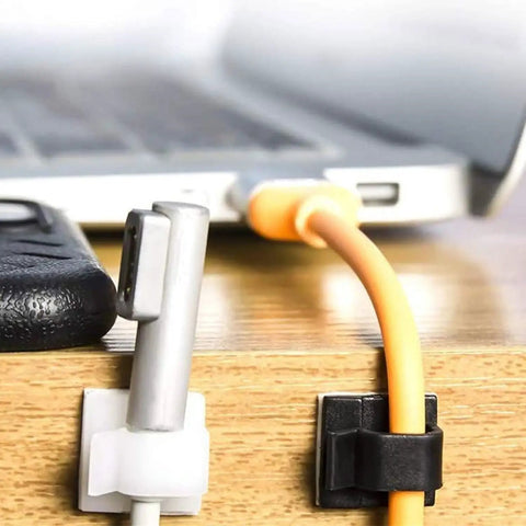 50 Pack Cable Clips With Two Sizes Medium And Large White Wire Holder And Organizer For Car Office And Home Cable Management Clips For Desk TV Power Strip Computer And More shown organizing wires on a desk.