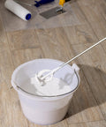 Heavy Duty Drill Paint Mixer Set Of 2 Paddles blending white paint in a bucket, compatible with standard drills for fast even mixing.