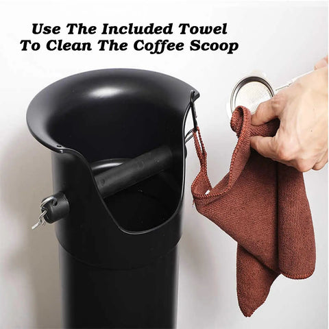 Game Changing Heavy Duty Vertical Espresso Knock Box For Pro Bars And Home Cafes With Reinforced Knock Bar And Spacious 8.6 Liter Grounds Bin Built On A Rock Solid Anti Skid Platform In Clean White, showing cleaning towel with coffee scoop.