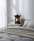 Handmade Korean Wood Lamp With Pagoda Design Asian Table Lantern For Nightstand And Bedroom Cozy Brown Oriental Light Rustic Hanok Style Home Decor Authentic Craftsmanship Great Gift Idea For Home on a bedside table.