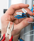 Close-up ceramic wire connectors (porcelain twist caps) for 22-14 AWG; blue and brown wires being joined.