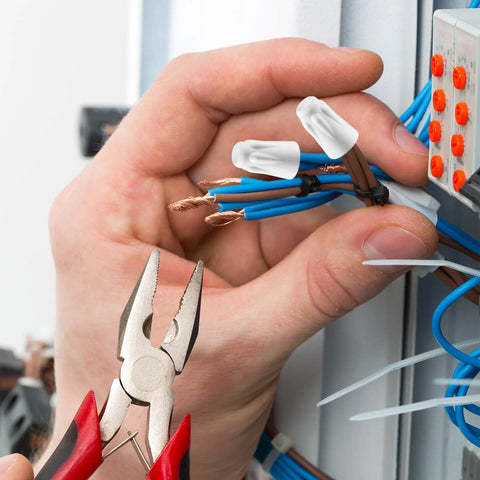 Close-up ceramic wire connectors (porcelain twist caps) for 22-14 AWG; blue and brown wires being joined.