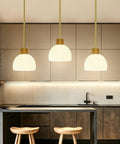 PRTILOUD Pendant Lights Kitchen Island, Modern Gold Hanging Light Fixture with Glass Shade over kitchen island.