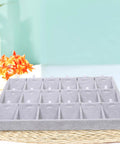 Large Grey Velvet Jewelry Tray With 18 Grid Dividers For Necklace And Watch Storage Soft Lined Organizer Dish displayed on a desk.