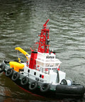 Heng Long 2.4G RC Fire Fighting Boat With Water Spray Cannon on water, red and white design, durable build for hobbyists, realistic model.
