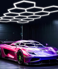 Hexagon LED Garage Lights Kit With 456W Output And 6500K Daylight illuminating a sports car in a garage, 14 hex panels visible