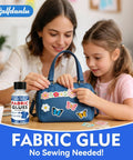 Mother and daughter decorating blue bag with Permanent Fabric Glue That Sticks Like A Dream, bottle visible on table.