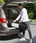 Person placing 13x13 Pop Up Hexagonal Gazebo Canopy Shelter With Mesh Netting for lawn and backyard in car trunk.