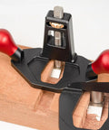 Tough As Nails Handheld Router Plane Featuring Adjustable Stainless Steel And Ebony Blades on wood for precise edge trimming.