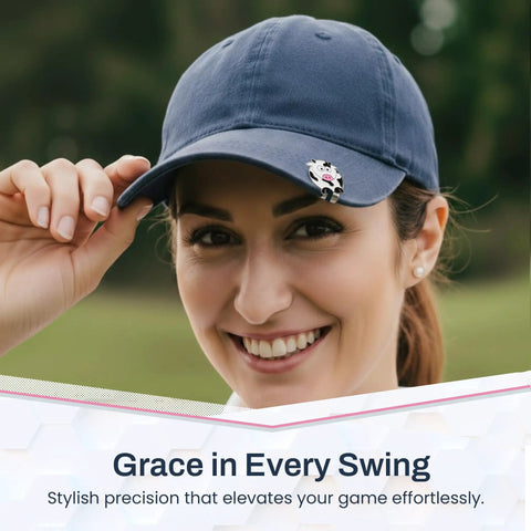 Smiling woman wearing cow shaped golf ball marker with hat clip, a cute durable metal golf accessory for women golfers.
