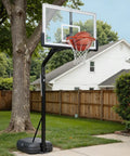 Basketball hoop in backyard setup showing Heavy Duty Replacement Basketball Rim 18 Inch Solid Steel Pro Grade Hoop Rim For Wall Mount And Backboard Replacement With Double Spring Design And Heavy Duty Net Includes Complete Installation Kit Game Ready For Fast Setup.