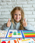Child smiling with Magnetic Fraction Tiles And Circles Set With Dry Erase Board For Visual Math Learning on table.